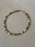 Fawn Necklace in green and gold — moss green glass beads with scattered pearls and 18K gold detailing, handmade by Salty Gypsy