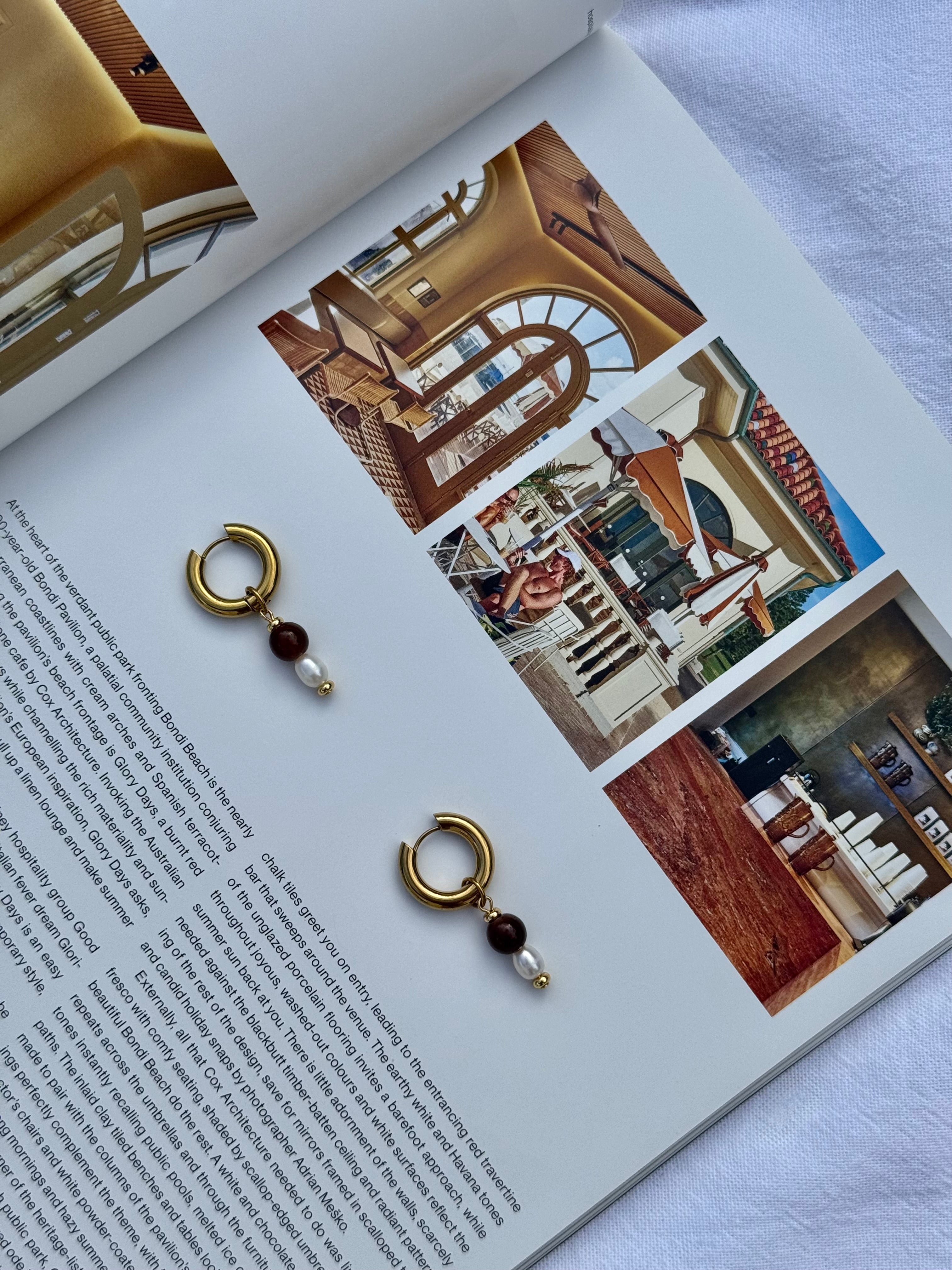 Harlow chunky gold huggie hoop earrings with brown glass bead and freshwater pearl charm, handmade statement jewellery by Salty Gypsy