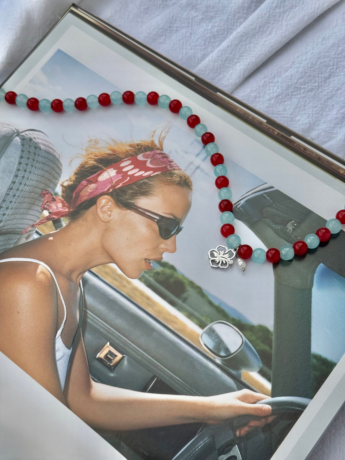 Hot Tropic silver beaded necklace handmade with blue and red glass beads, hibiscus charm and rice pearl by Salty Gypsy
